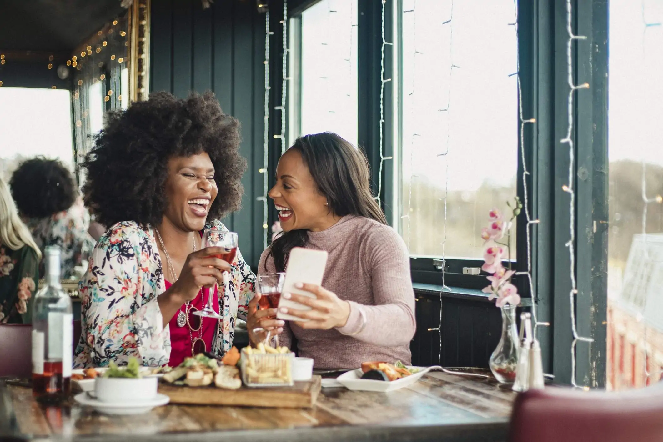 Two customers are in a restaurant and they are l