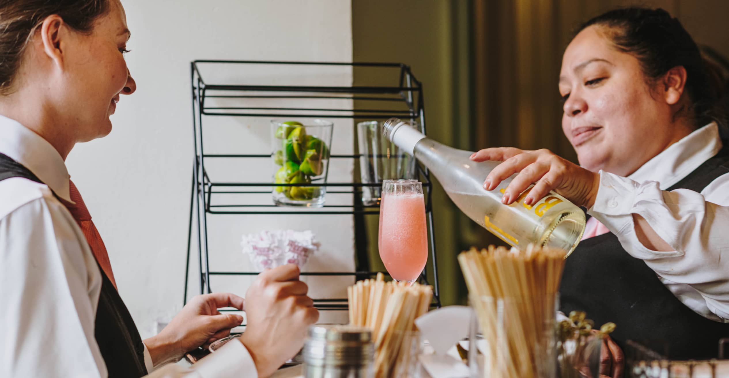 women serving cocktail